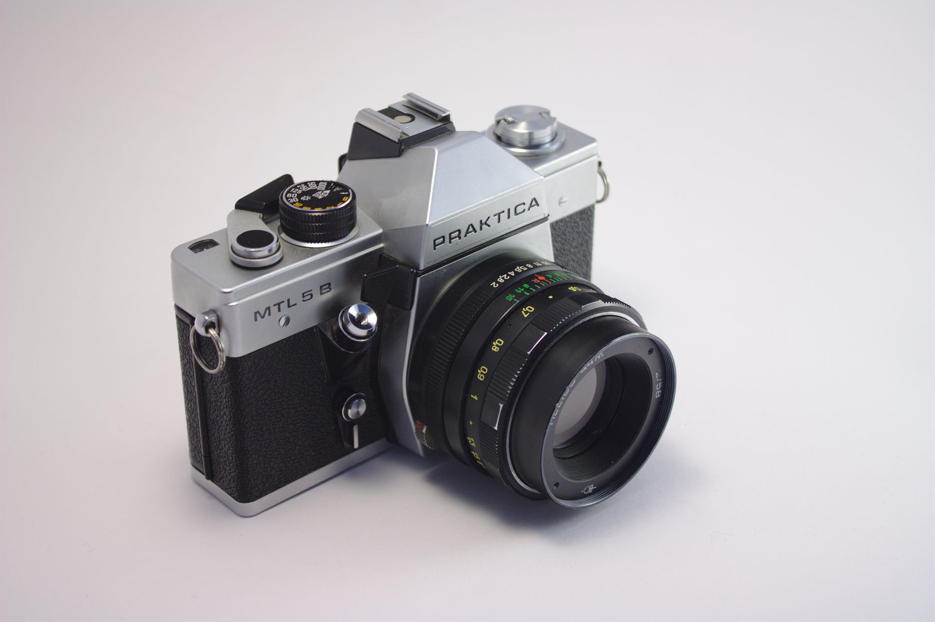Close-up of a classic Praktica MTL5 B analog camera with attached lens.