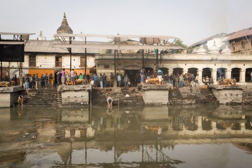 Free People gathering for rituals by the river in Kathmandu, showcasing cultural traditions. Stock Photo