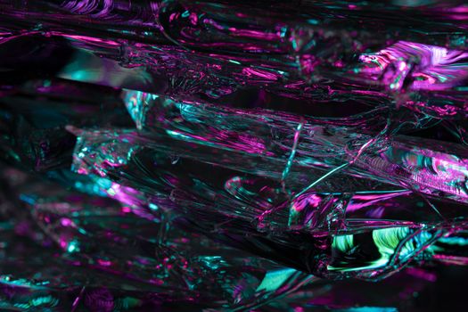 A vibrant abstract image featuring pink and green crystal reflections with artistic lighting.
