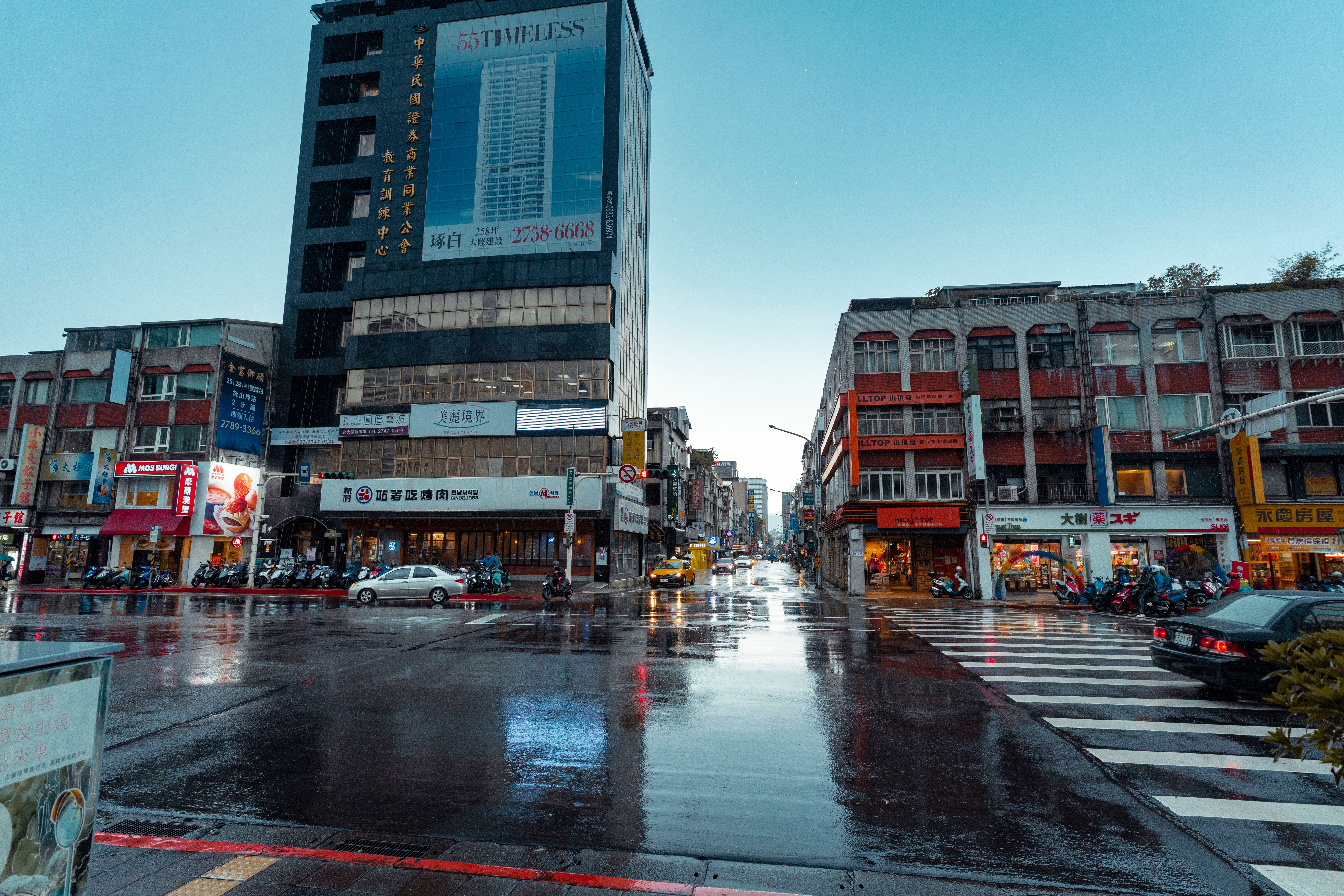 People walking with umbrellas on a rainy street in Taipei, Taiwan.