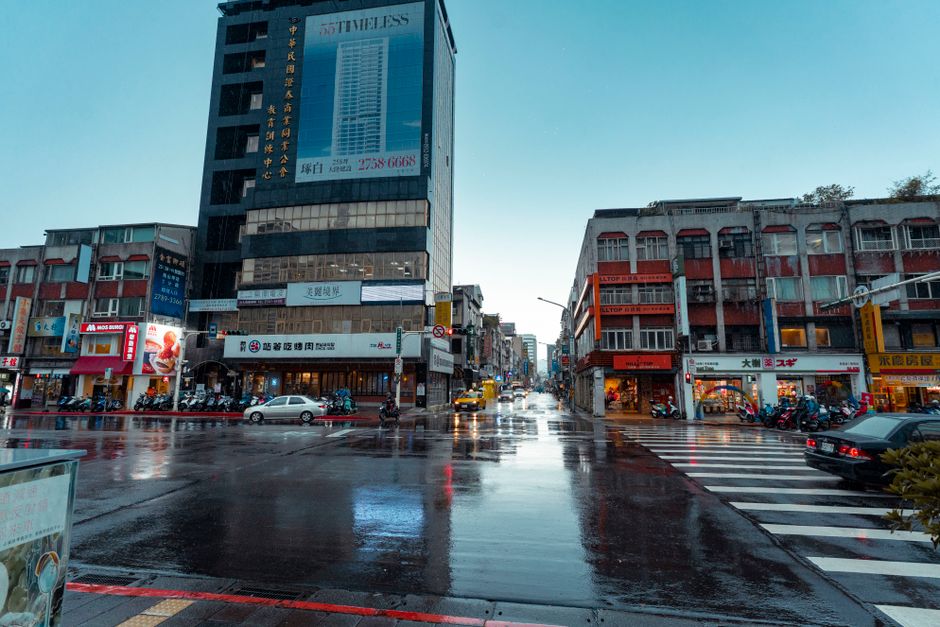 People walking with umbrellas on a rainy street in Taipei, Taiwan.