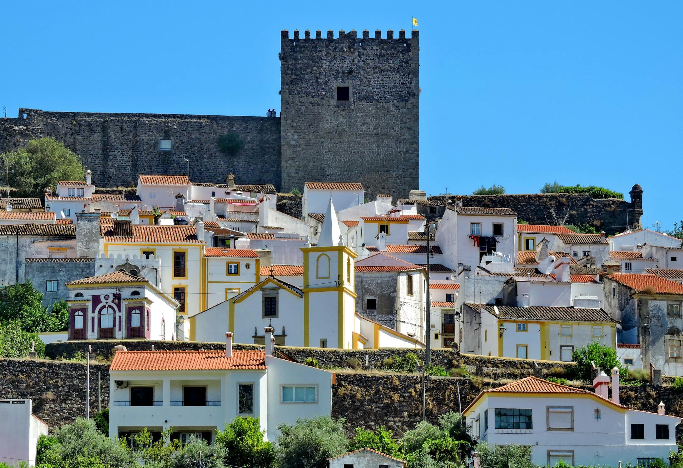 Photo of White Houses near a Church