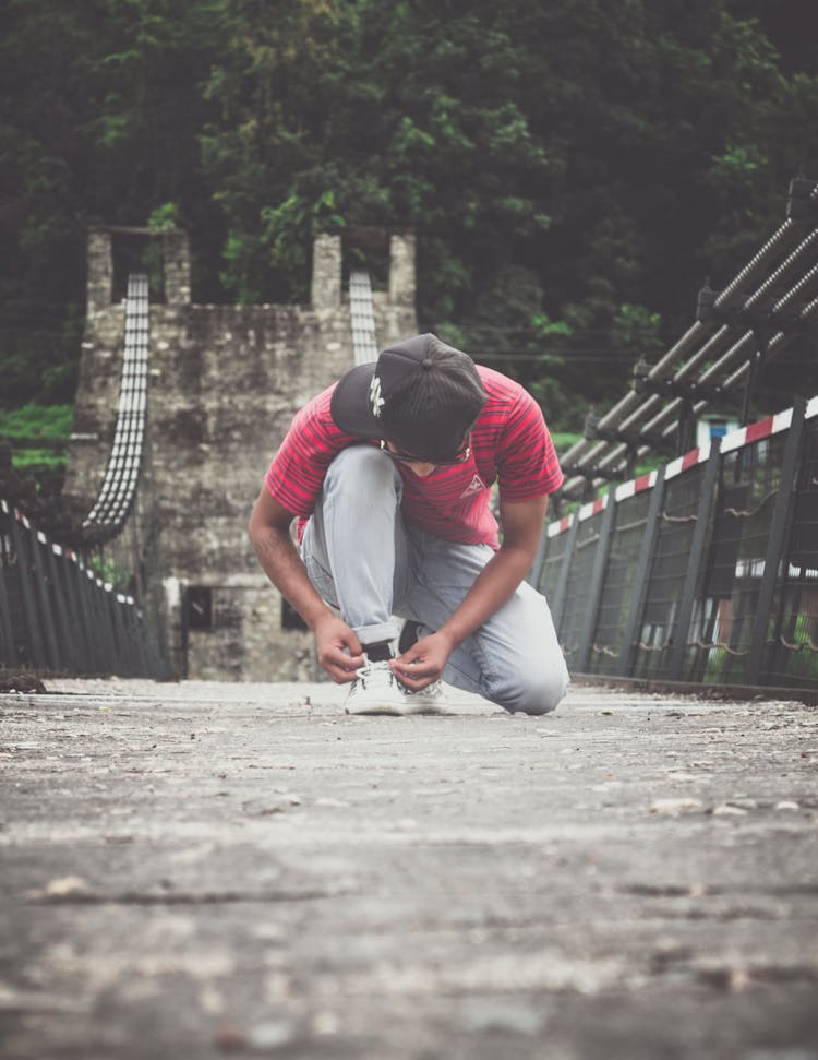 Person Tying His Shoe Lace