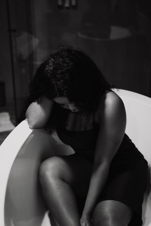 Grayscale Photo of a Woman in a Bathtub