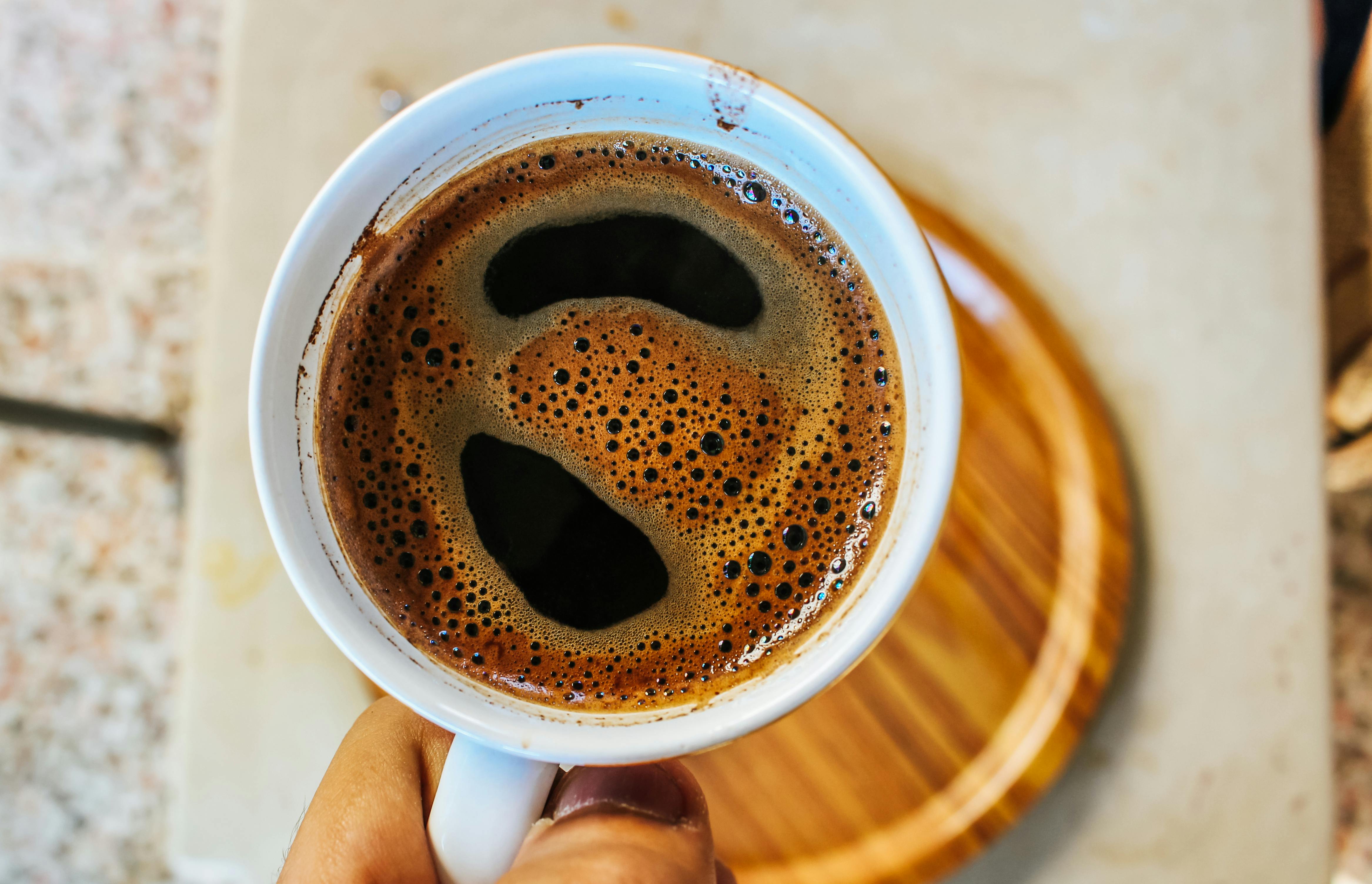 Selective Focus Photography Coffee Cup on Board · Free Stock Photo