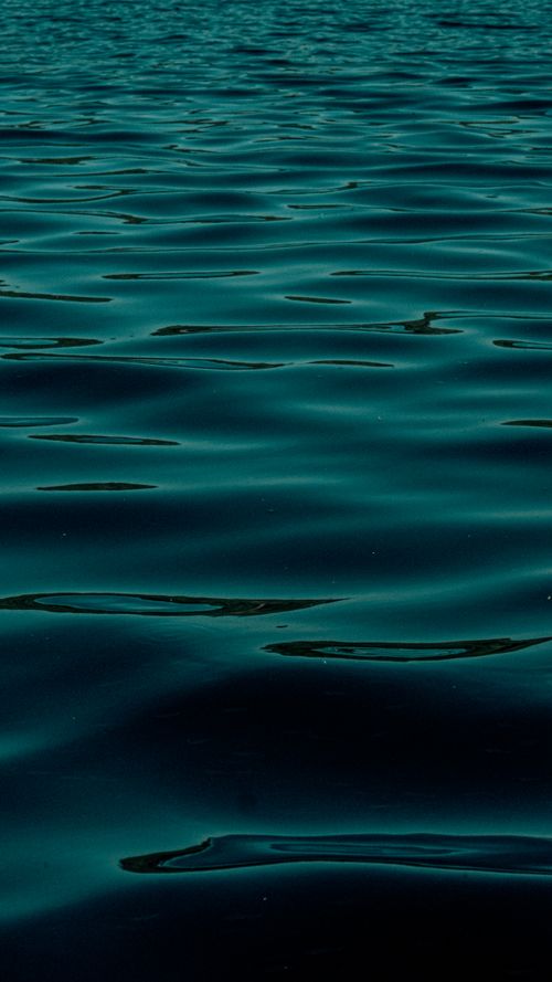 Free Gently rippling ocean surface captured at twilight, evoking tranquility and calmness. Stock Photo