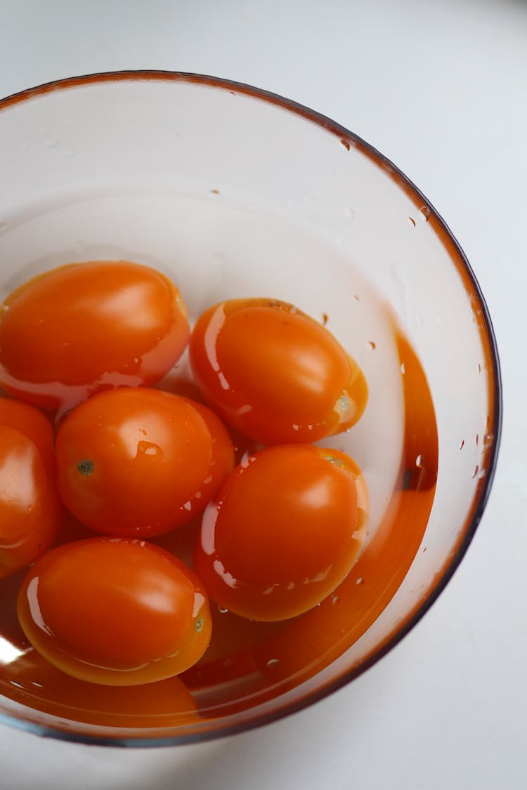 Fresh Tomatoes In A Bowl With Water