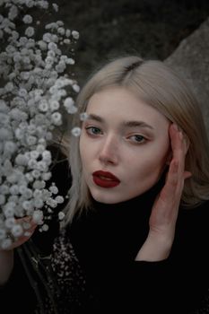 A striking portrait of a woman with red lips and Baby's Breath flowers, evoking elegance and mystery.