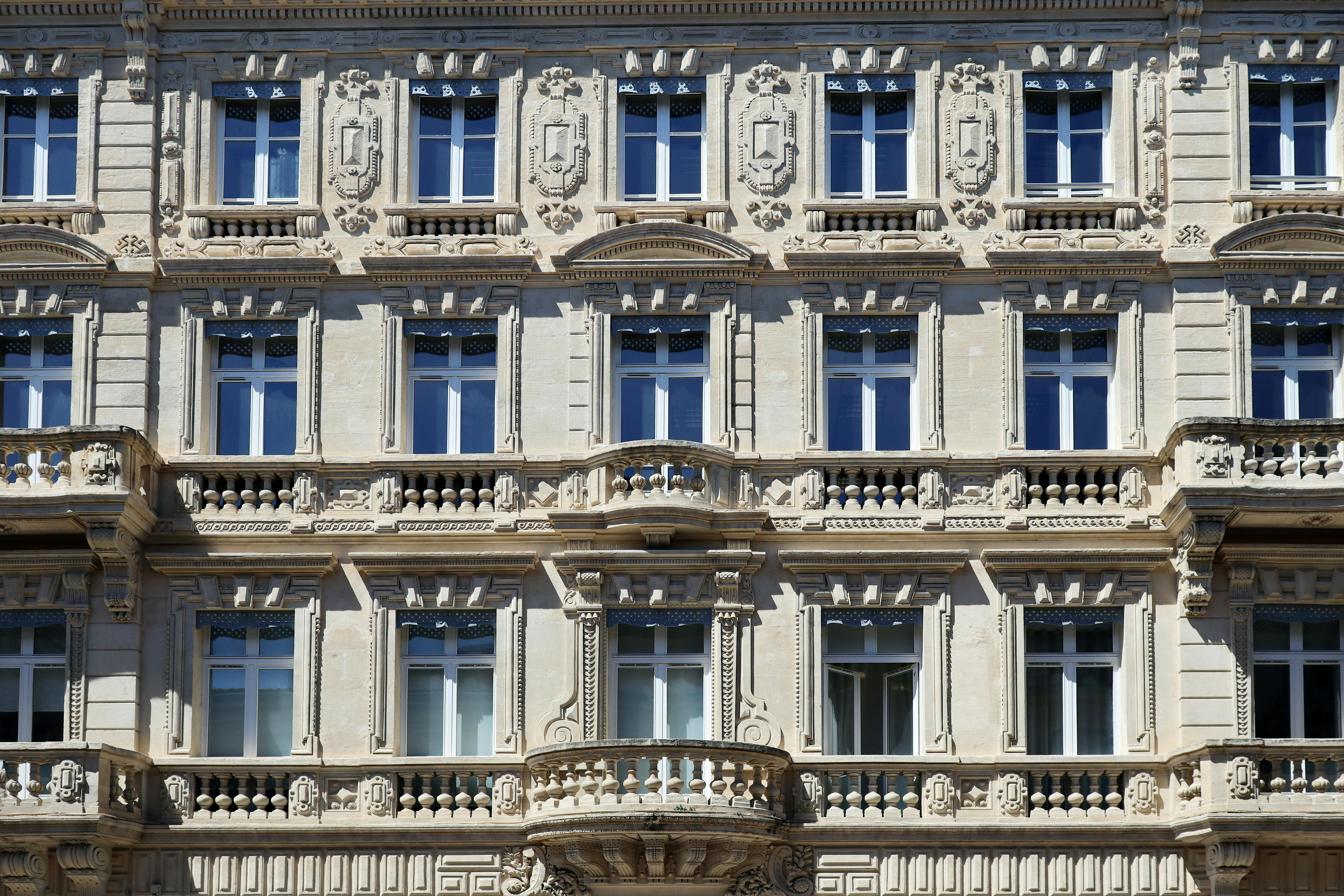 Ornate restored building facade with decorative balconies and classical architectural detail — the heritage architecture of a centuries-old colonial district.