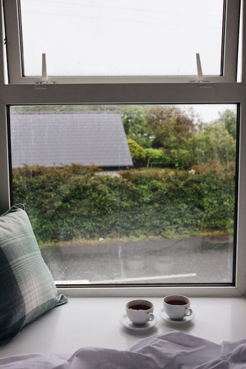 Tea Cups and Pillow on Windowsill