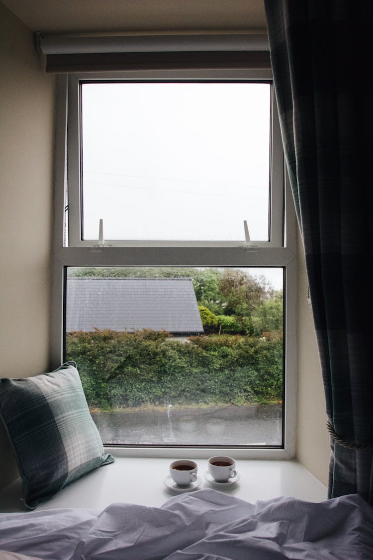 Tea Cups And Pillow On Windowsill