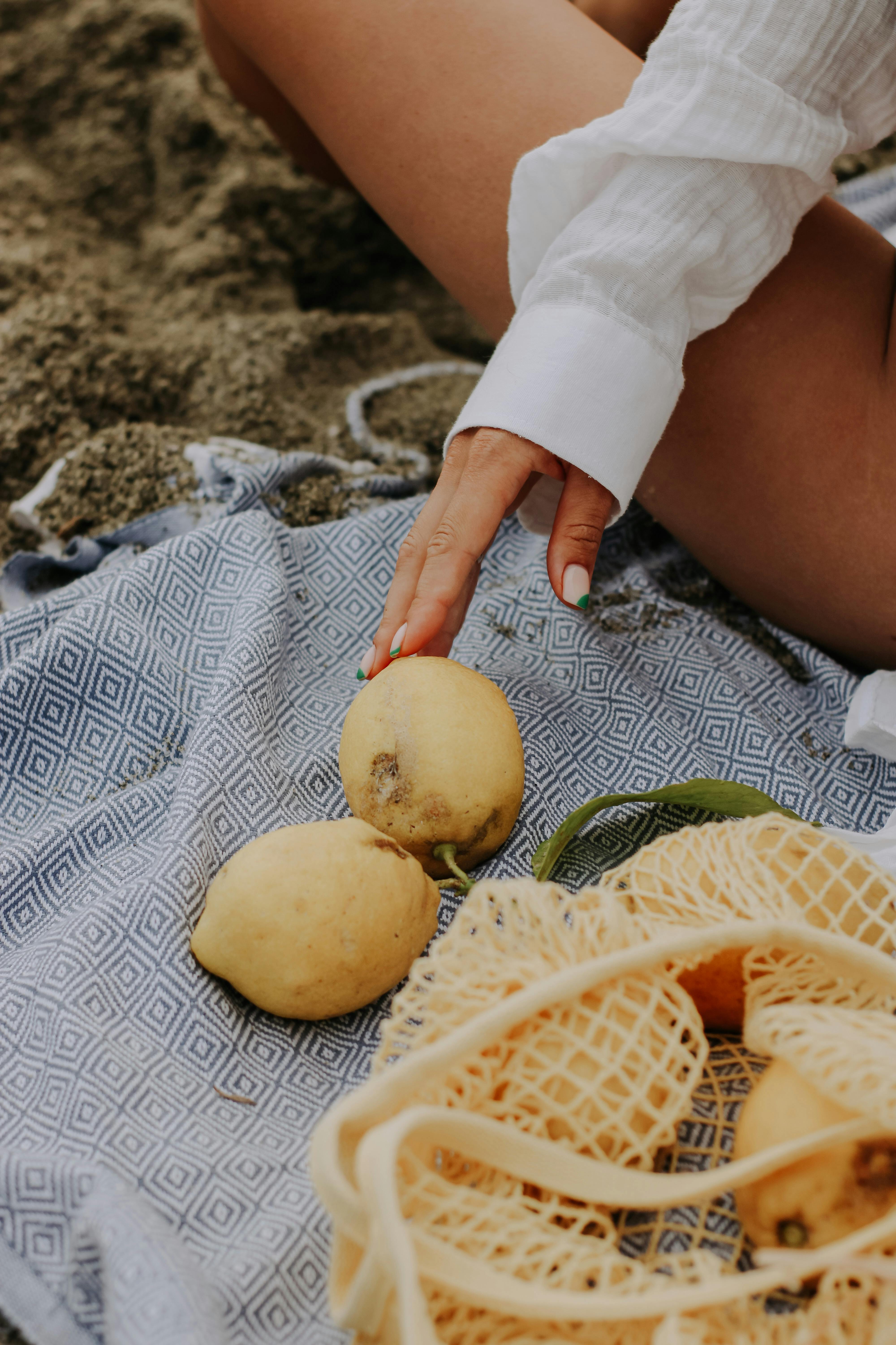 Lemon in a mesh bag. Stock Photo by Maliflower73