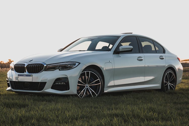 A White BMW 3 Series On A Field