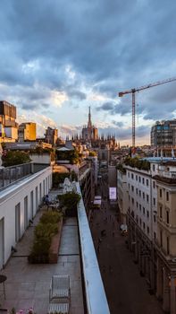 A breathtaking view of Milan from the Terrazza del Duomo with urban skyline and sunset.