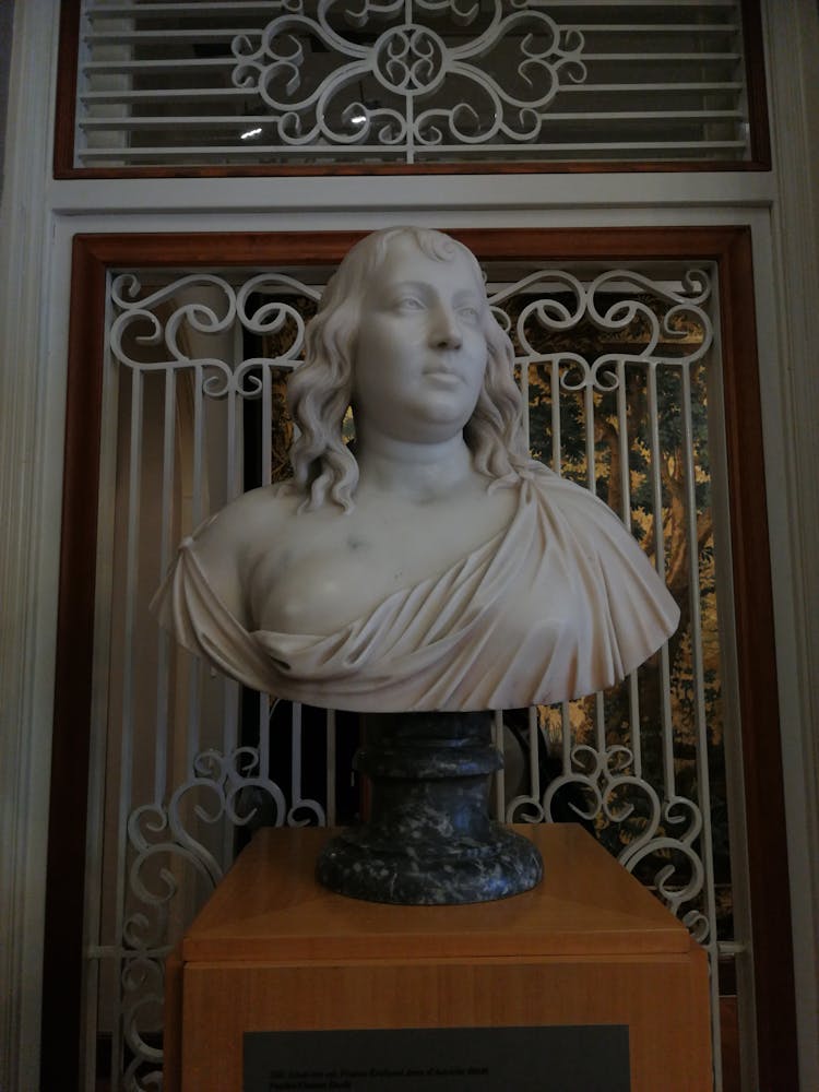 A Sculpture Of A Bust Of A Woman