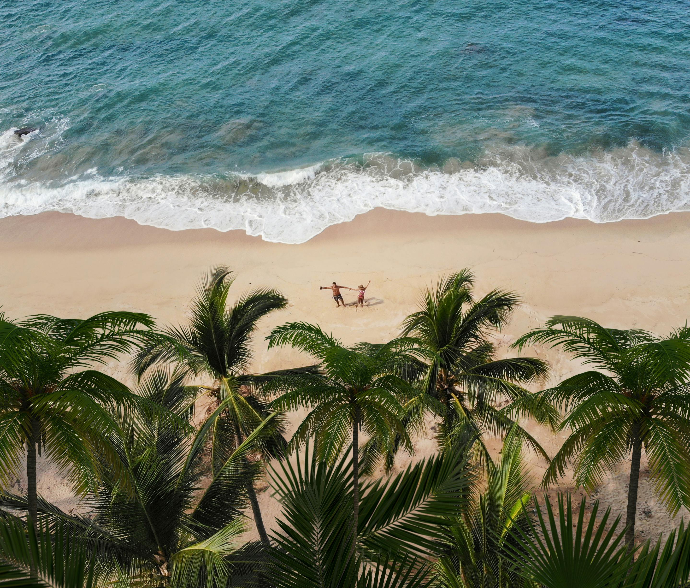 an aerial shot of a couple on a beach