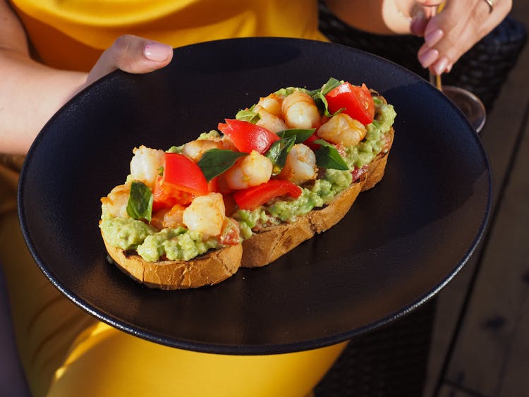 Photo Of A Black Plate With Bread And Guacamole