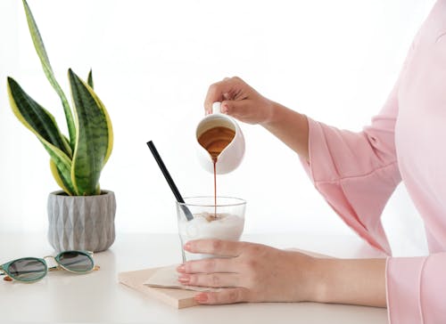 Free Woman Pouring Honey on Desert Stock Photo