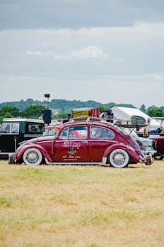 A classic red Volkswagen Beetle parked outdoors, capturing retro automotive charm.