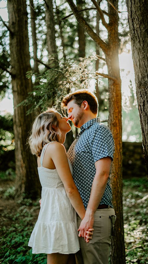 A Couple Holding Hands in a Forest