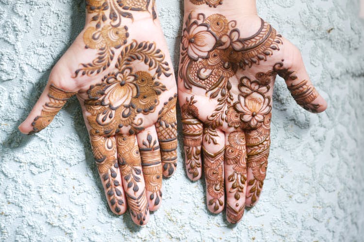 A Person's Hands With Mehndi