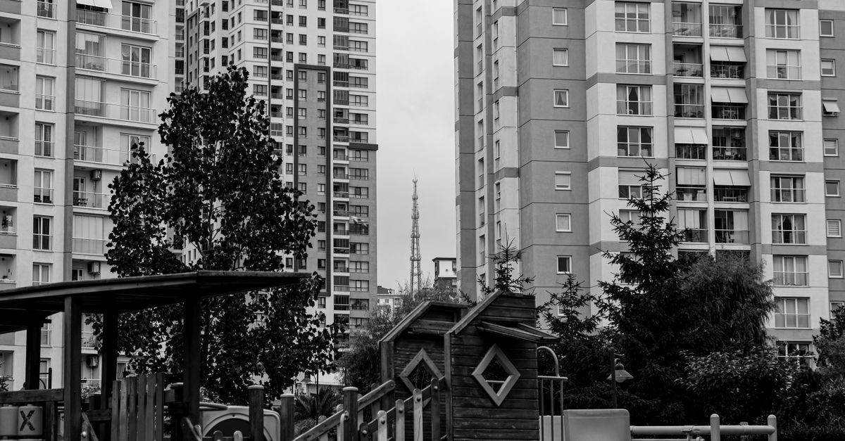 Black and white photo of a playground surrounded by high-rise apartments in Istanbul, Turkey.