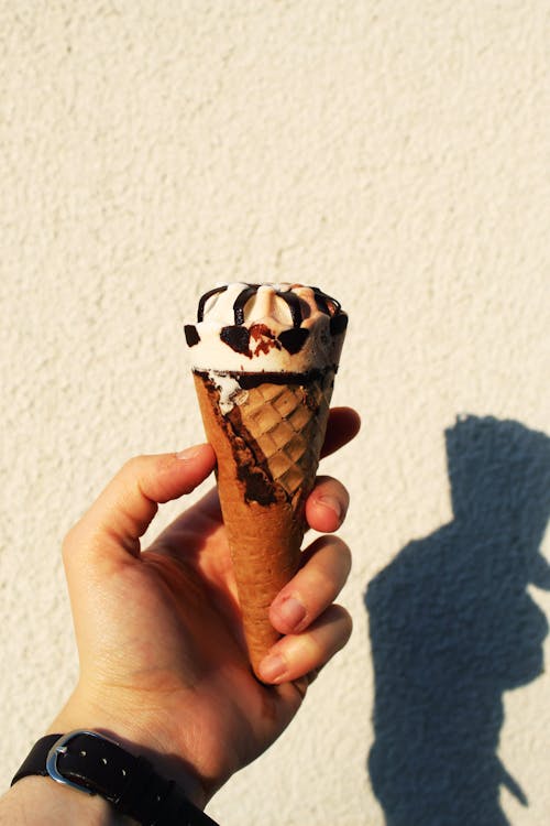 Free A Person Holding an Ice Cream Cone Stock Photo
