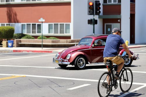 Man in Blue Shirt Riding Bicycle