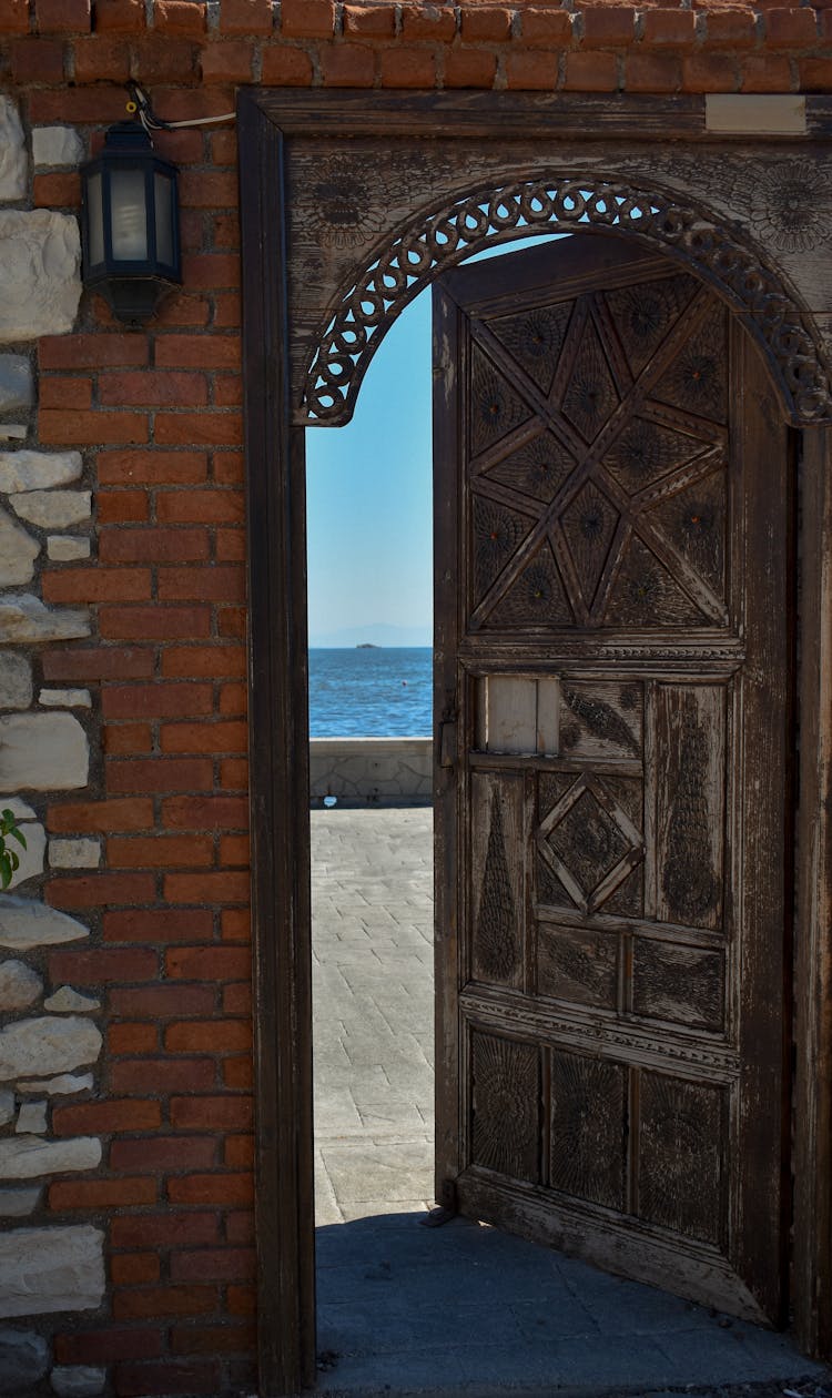 Photo Of An Open Door Near A Lamp