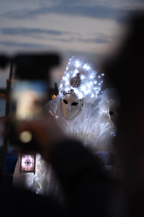 Photo of a Person in a White Costume