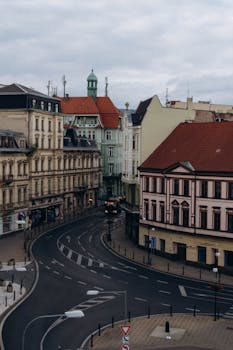 Charming aerial shot of an empty European street lined with historic buildings.