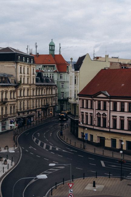 Charming aerial shot of an empty European street lined with historic buildings.