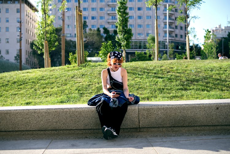 Redhead Attractive Girl Sitting And Texting On Mobile Phone