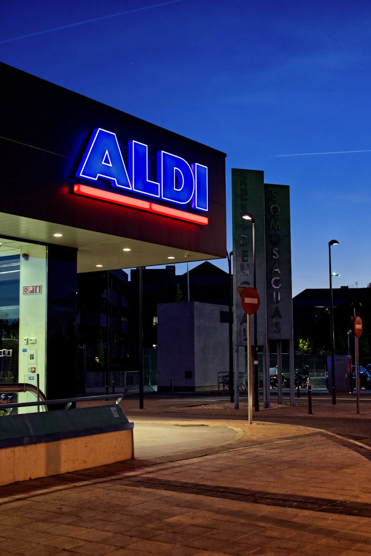 Illuminated Entrance To Supermarket At Night