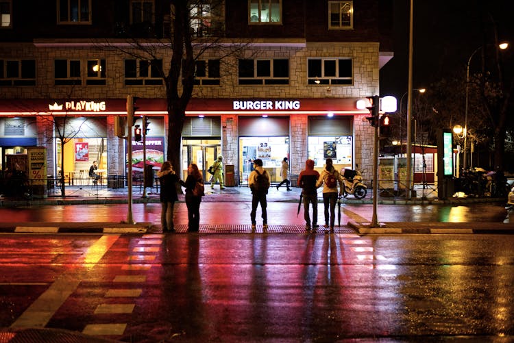 Photo Of People Waiting To Cross A Road