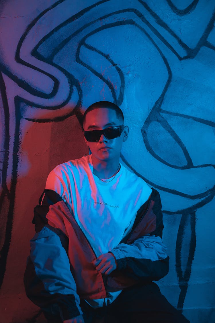 Man In Sunglasses Posing In Blue Lit Room