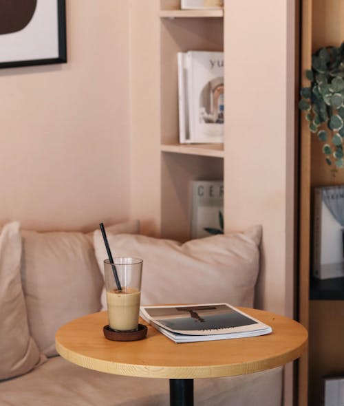 Photo of a Magazine and a Glass of Iced Coffee on a Table