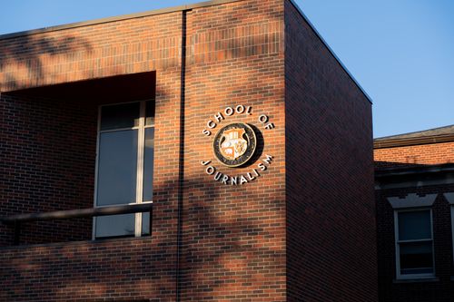 Free The brick facade of the School of Journalism building in Columbia, MO, captures the setting sun's glow. Stock Photo