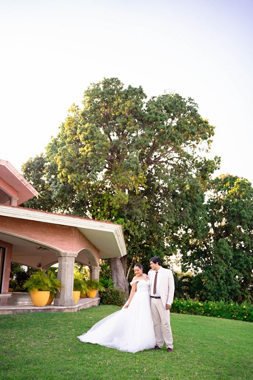 Bride and Groom Standing on Grass