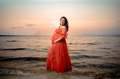 Pregnant Woman in Orange Dress