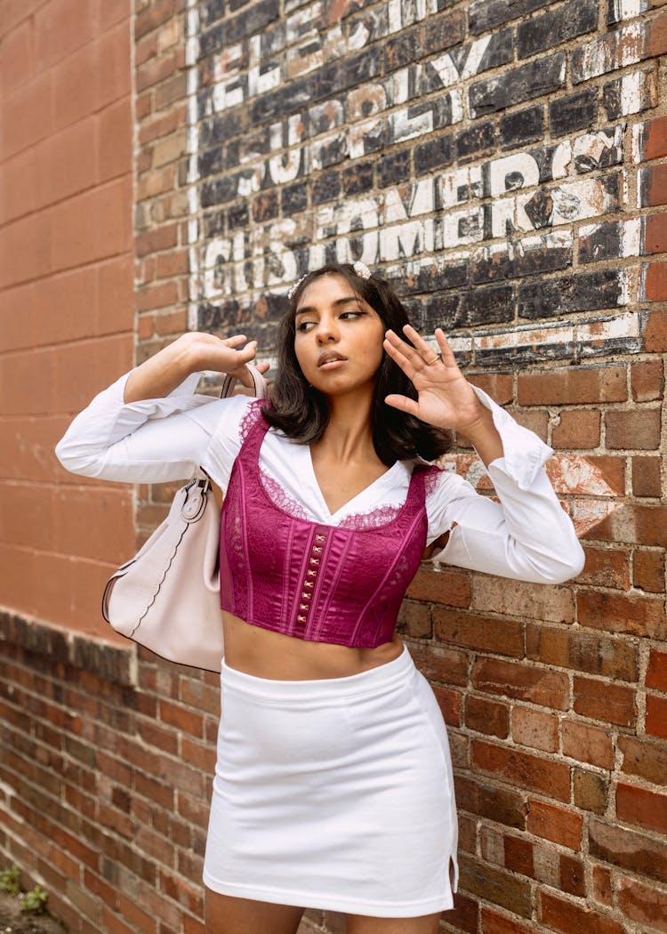 Attractive Brunette Girl Posing For Fashion Photo In Street