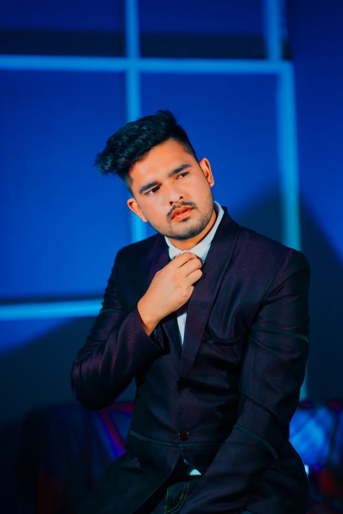 Free Elegant South Asian man in a suit glances confidently to the side in an indoor setting. Stock Photo