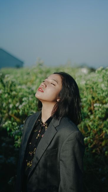 Portrait of a woman in a suit enjoying the outdoors in Indonesia.