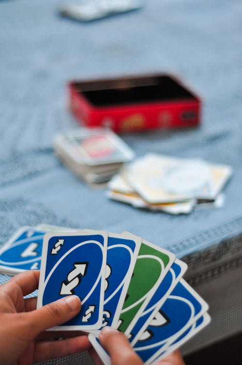 A Person Holding an Uno Cards