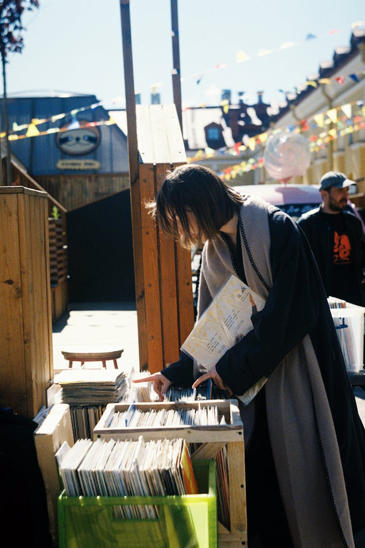 Woman Buying Vinyl CD On Market