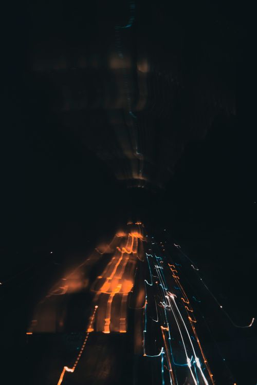 Free Artistic long exposure capturing blurred city lights at night. Stock Photo