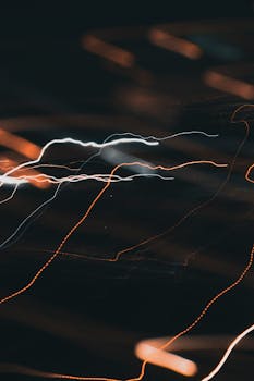 Abstract image featuring dynamic light trails against a dark backdrop.