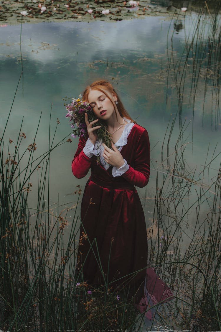 Woman In Gown Posing With Flowers In Water