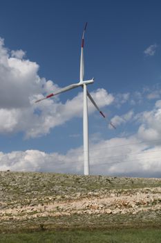 White Wind Turbine Under Blue Sky