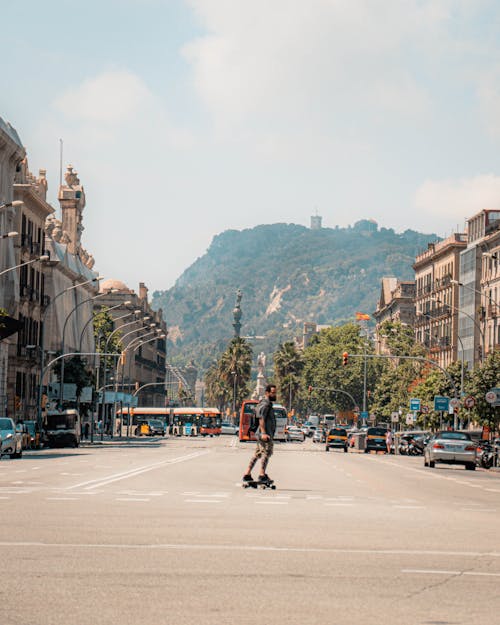 A Man Riding a Skateboard on a Road